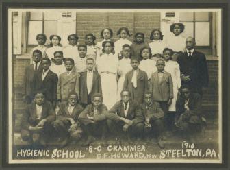 Twenty-seven students of the grammar class pose with principal Charles F. Howard in 1910.  Click for a larger image.